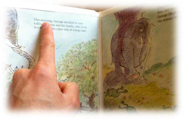 We can help our kids learn to read by pointing at the words as we read children's stories with them